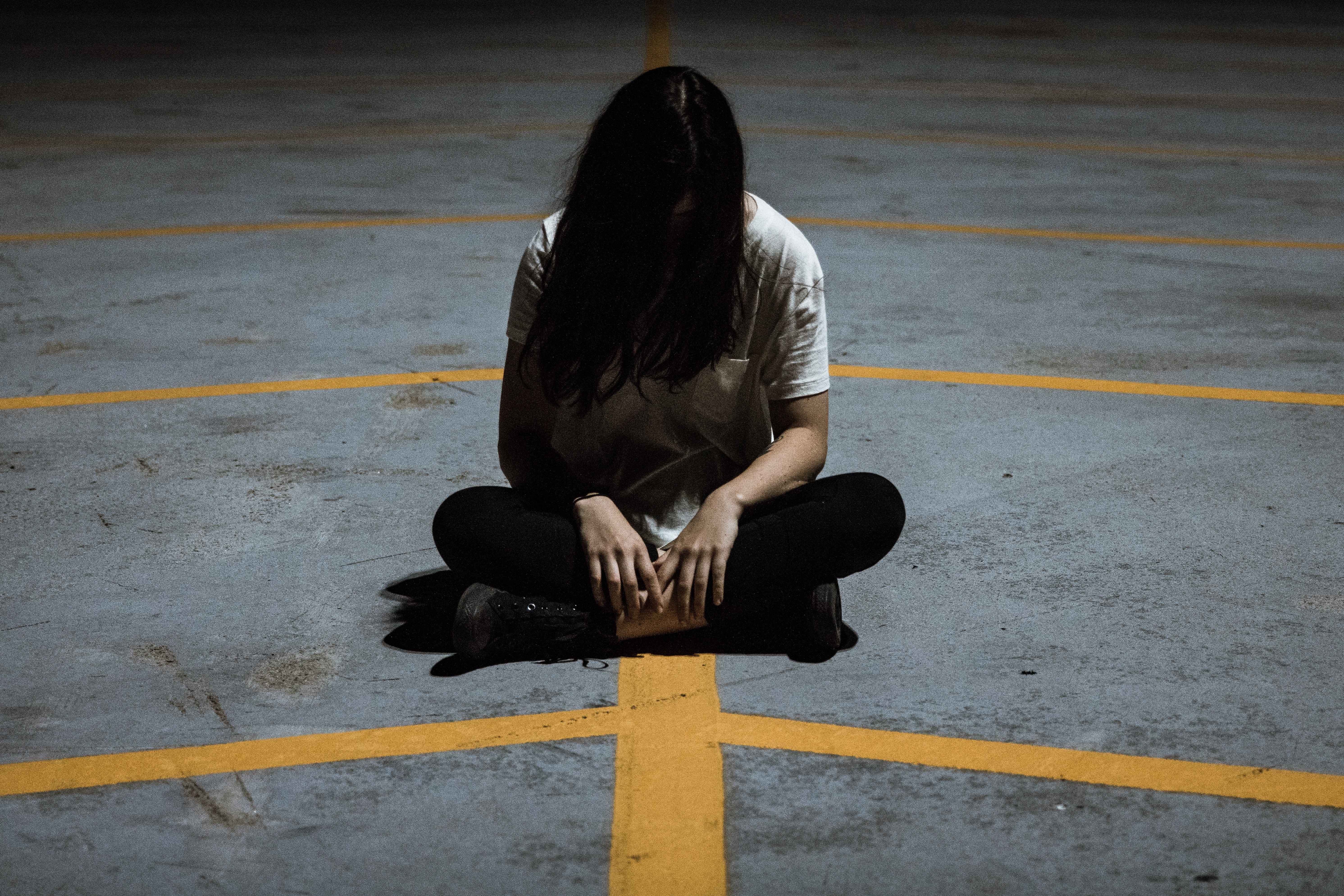 Girl sitting dejected on ground