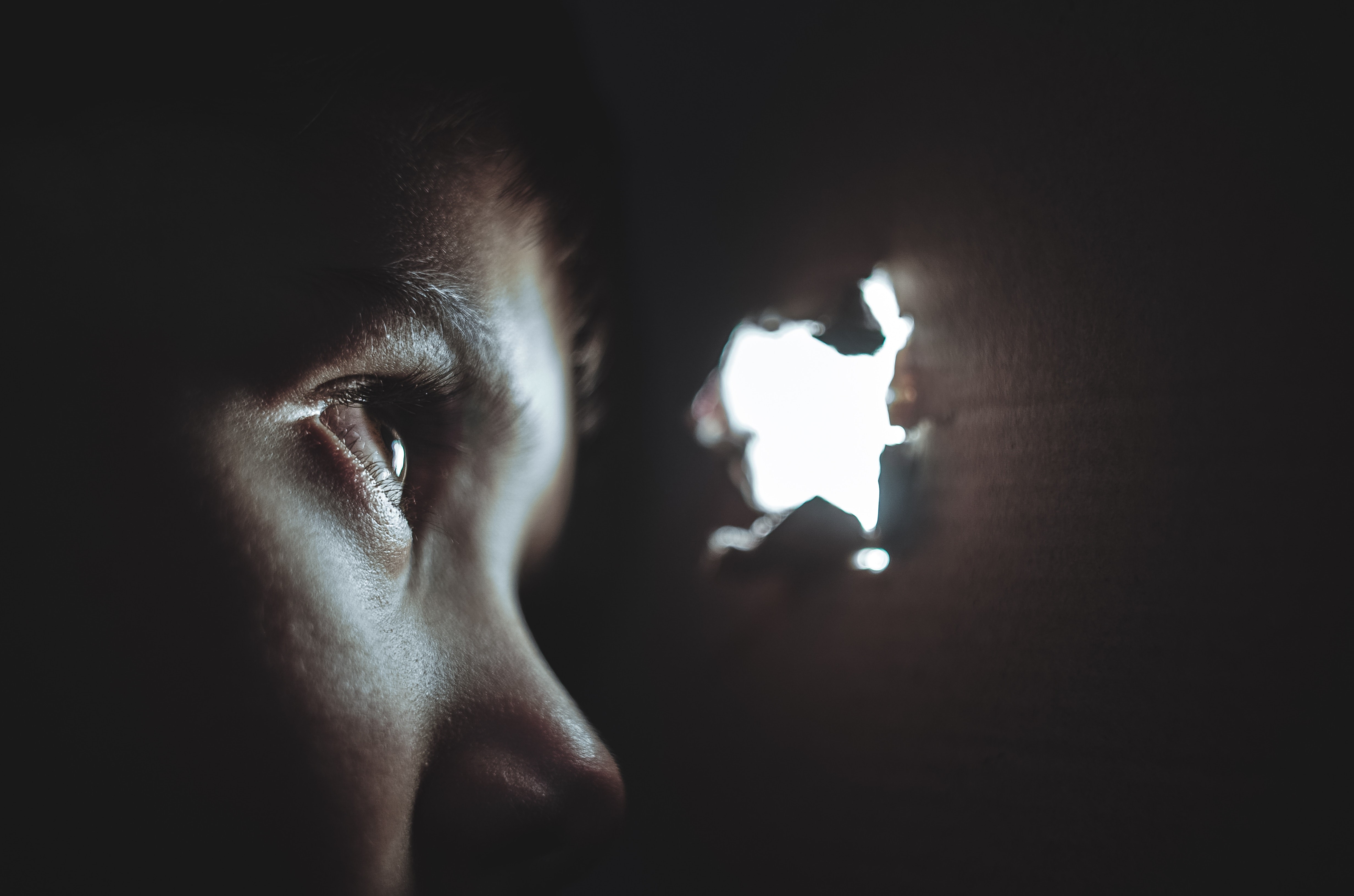 Child looking through hole