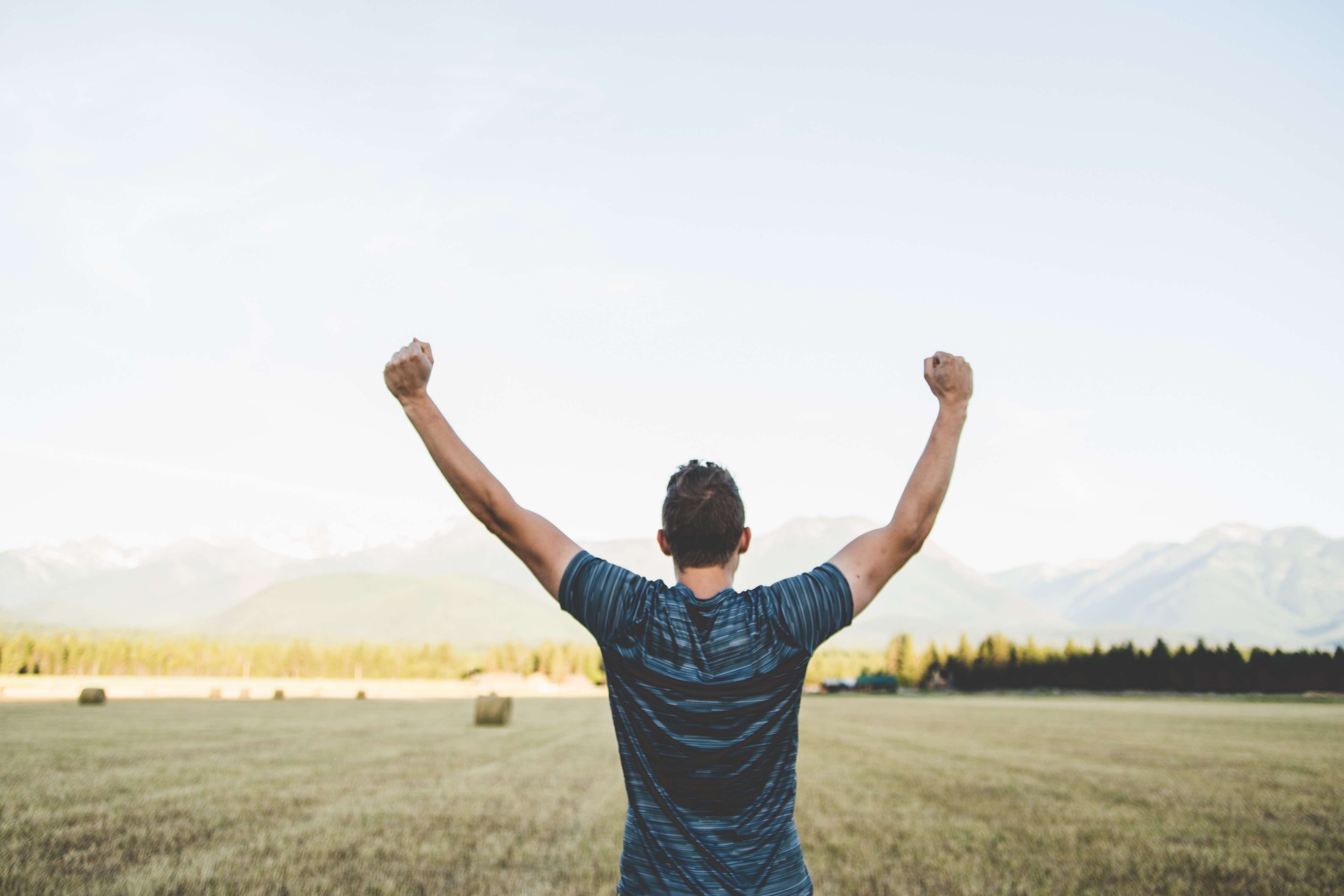 Man celebrating finishing baling crops